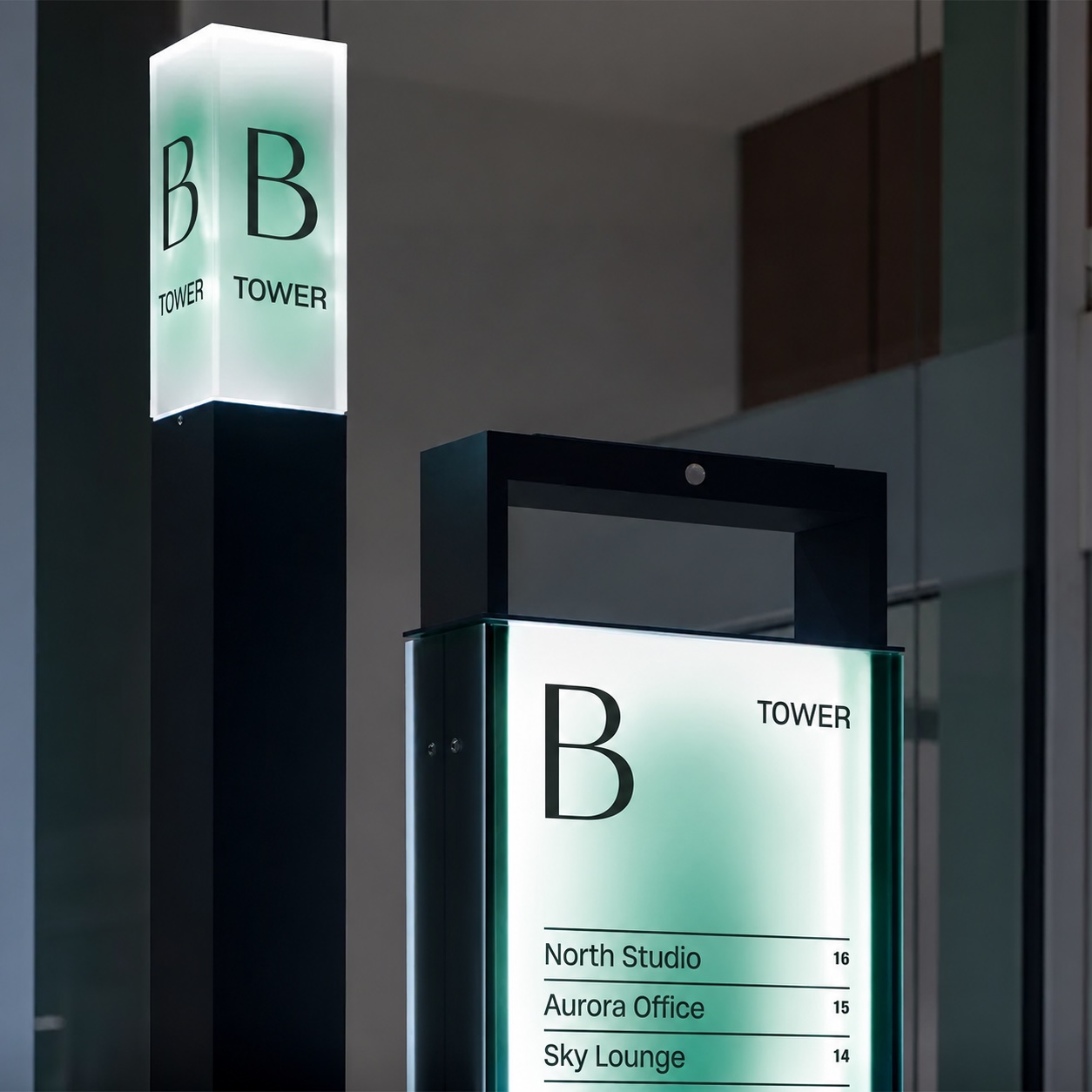 Illuminated directory pylons in a contemporary building interior.