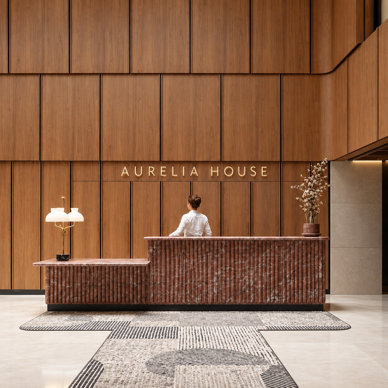 Dimensional identity lettering behind a hospitality reception desk.