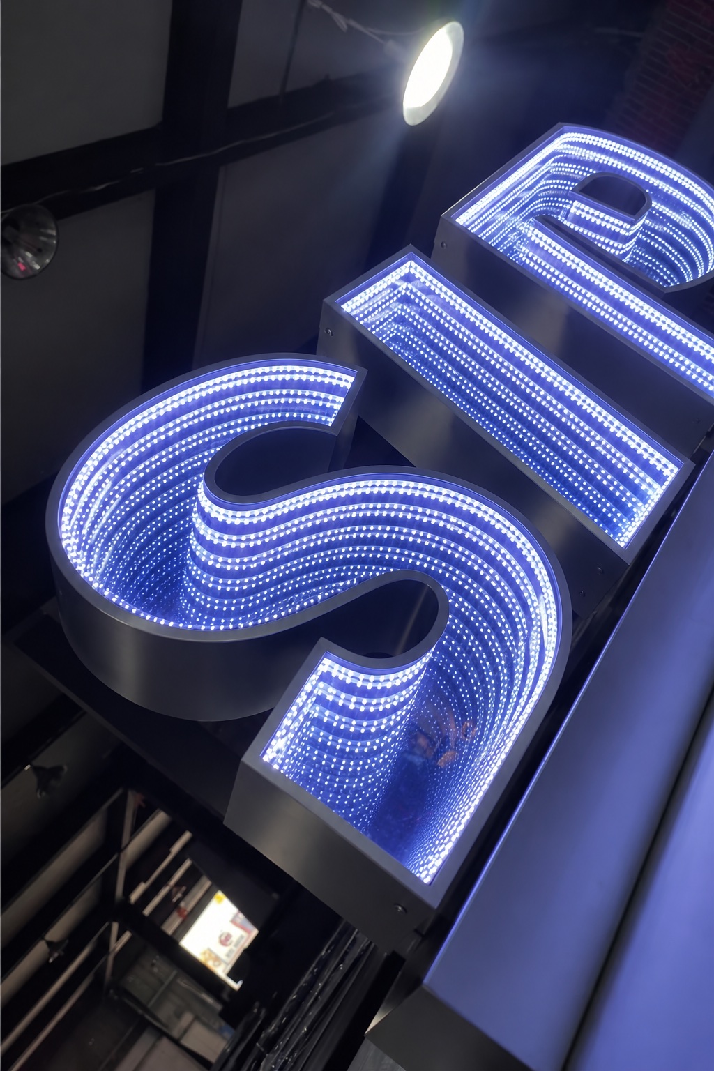 Dimensional letter with a mirrored infinity-light interior.