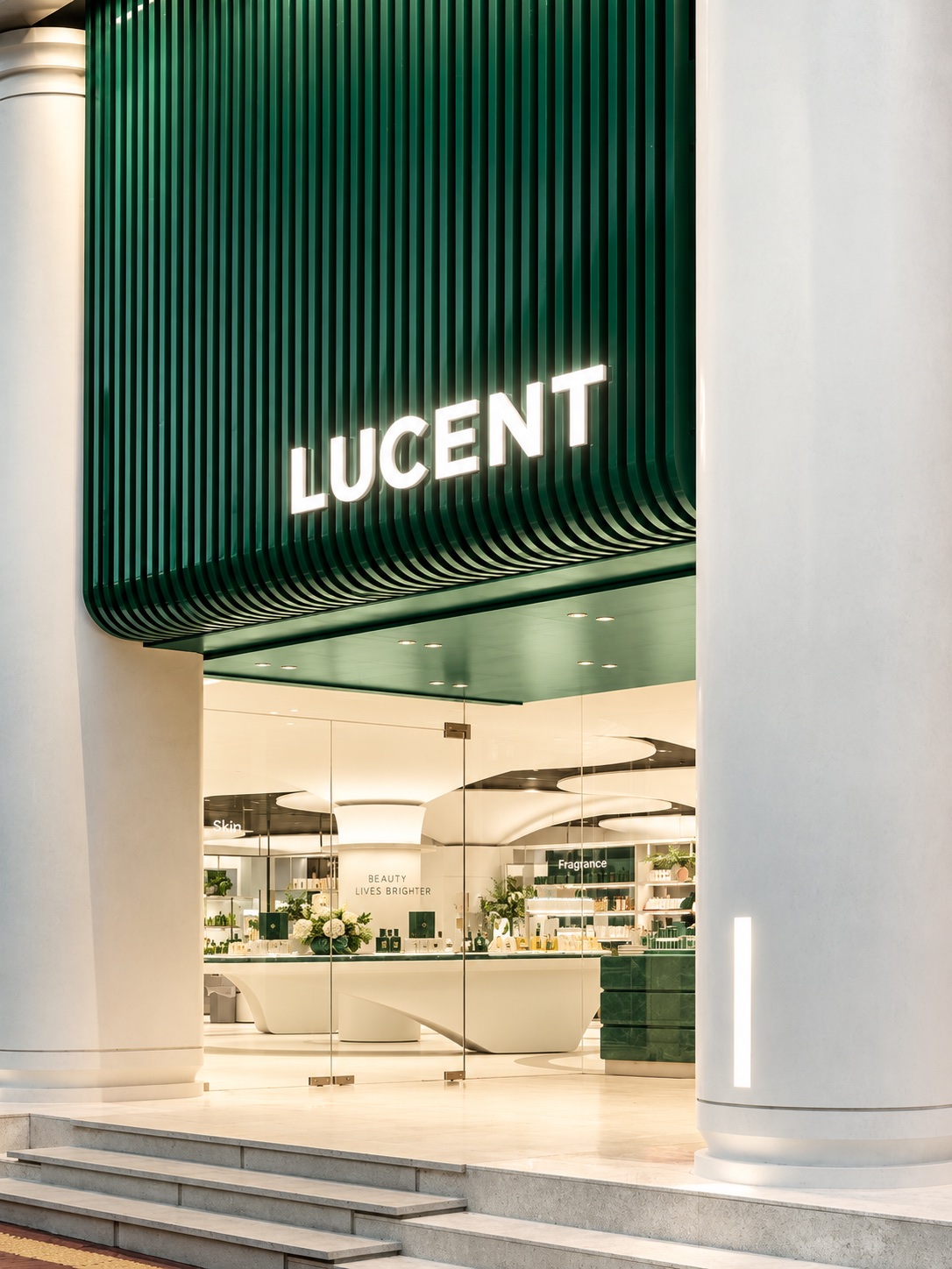 Branded retail entrance with illuminated dimensional lettering.